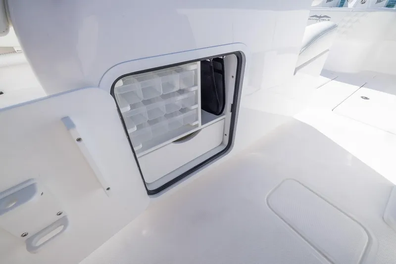 Slide: The Image of Storage compartment on 2025 Invincible 36 Open Fisherman boat, featuring organized tackle storage. - 17