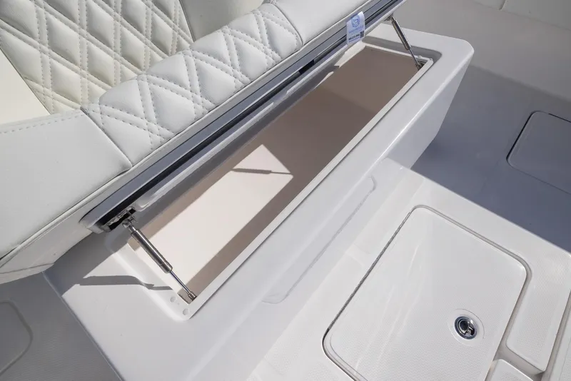 Slide: The Image of 2025 Invincible 36 Open Fisherman boat seat with storage compartment open. - 19