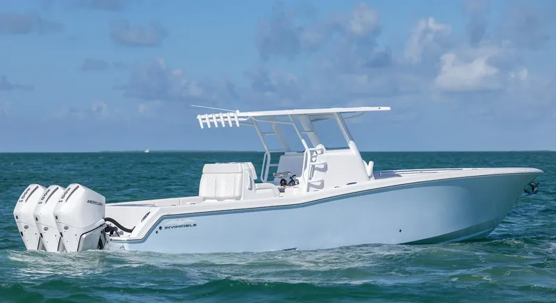 Slide: The Image of 2025 Invincible 36 Open Fisherman boat on the ocean, featuring triple outboard engines. - 2