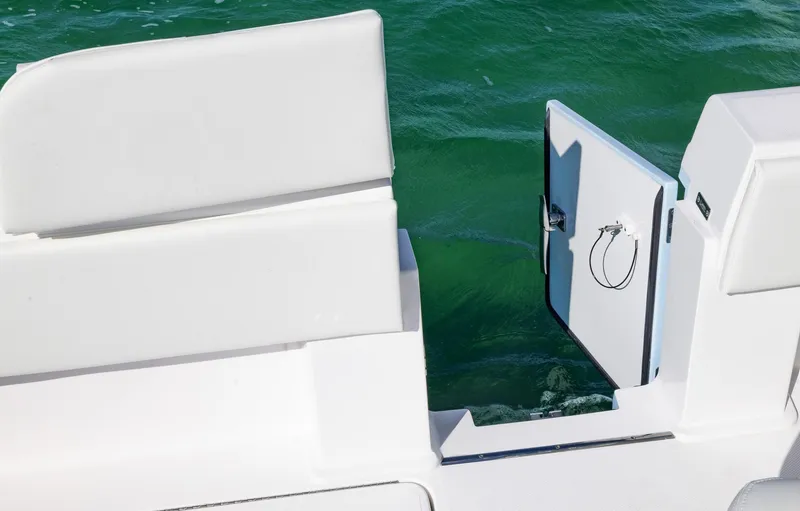 Slide: The Image of 2025 Invincible 36 Open Fisherman boat with open side door on turquoise water. - 20