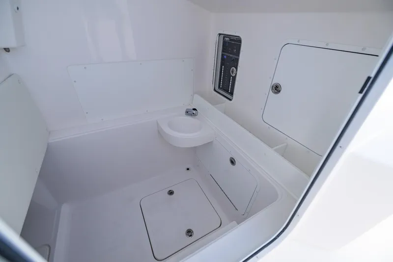 Slide: The Image of Interior of 2025 Invincible 36 Open Fisherman boat, featuring storage compartments and a sink. - 23