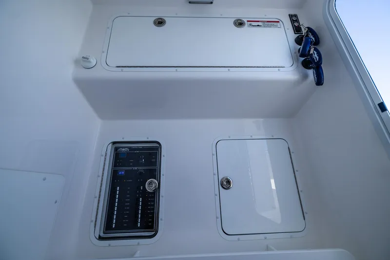 Slide: The Image of 2025 Invincible 36 Open Fisherman boat interior with storage compartments and control panel. - 25