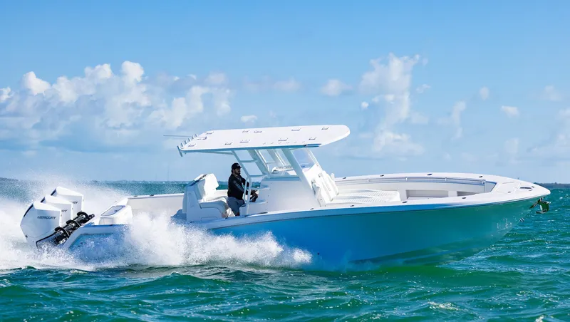 Slide: The Image of 2025 Invincible 36 Open Fisherman boat cruising on ocean under clear blue sky. - 39