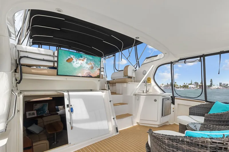Slide: The Image of 2002 Silverton 43 Motor Yacht interior with seating, TV, and ocean view. - 12