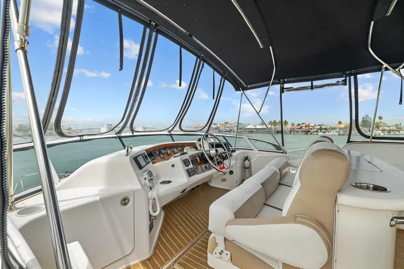 Slide: The Image of 2002 Silverton 43 Motor Yacht cockpit with panoramic windows and modern controls. - 15