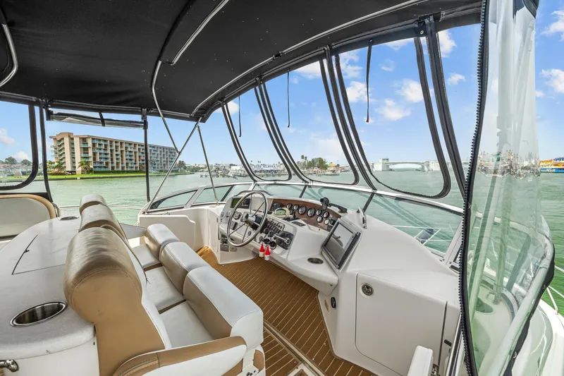 Slide: The Image of 2002 Silverton 43 Motor Yacht helm with modern controls and waterfront view. - 16