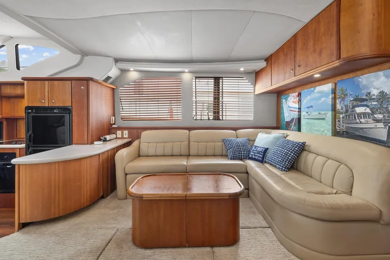Slide: The Image of Interior of 2002 Silverton 43 Motor Yacht with beige seating and wooden cabinetry. - 19