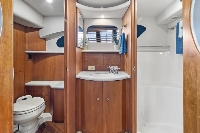 Slide: The Image of 2002 Silverton 43 Motor Yacht bathroom with wood cabinetry and modern fixtures. - 23