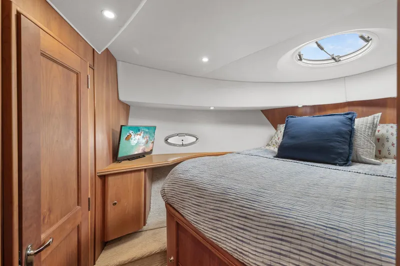 Slide: The Image of Luxurious bedroom in 2002 Silverton 43 Motor Yacht with cozy bedding and TV. - 27