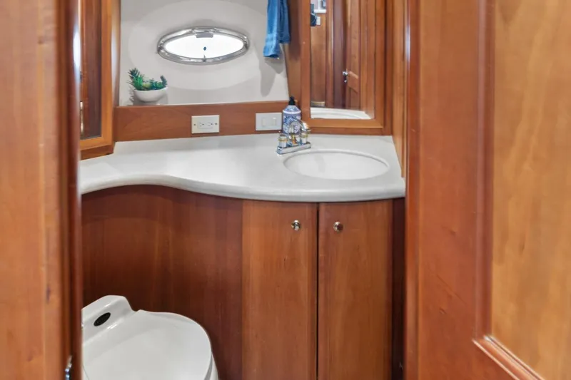 Slide: The Image of 2002 Silverton 43 Motor Yacht bathroom with wooden cabinetry and modern fixtures. - 28