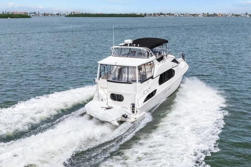 Slide: The Image of 2002 Silverton 43 Motor Yacht cruising on open water. - 4