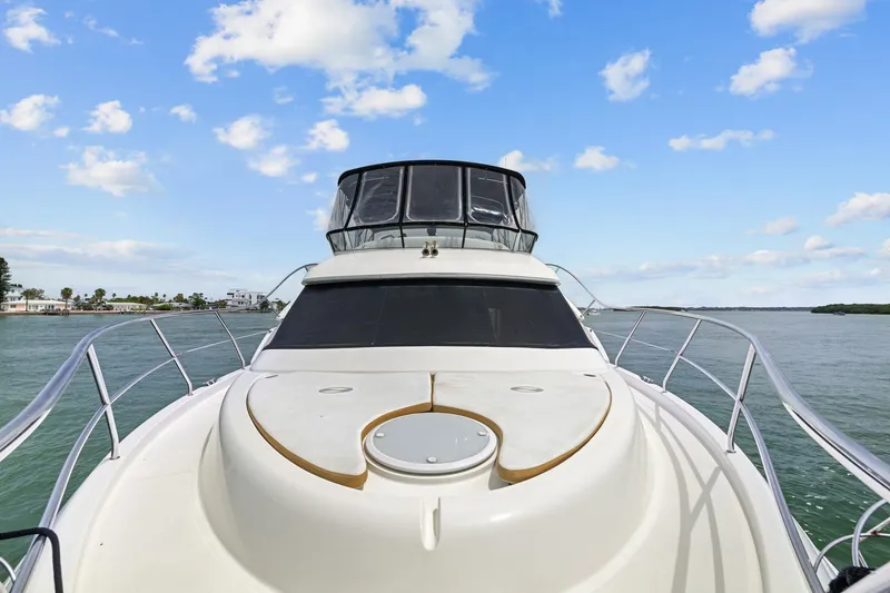 Slide: The Image of 2002 Silverton 43 Motor Yacht on calm water under a blue sky. - 9