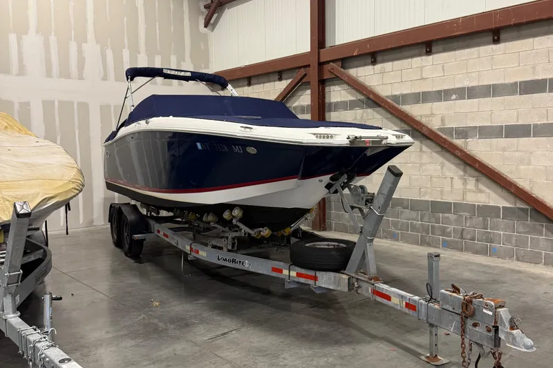 The Image of 2012 Cobalt 262 Bowrider boat on trailer in indoor storage facility. - 0