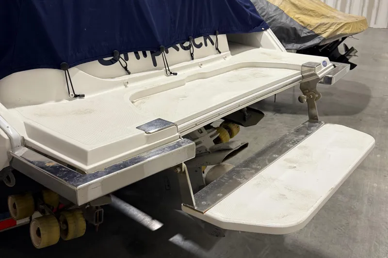 Slide: The Image of 2012 Cobalt 262 Bowrider swim platform with stainless steel details in a storage area. - 4