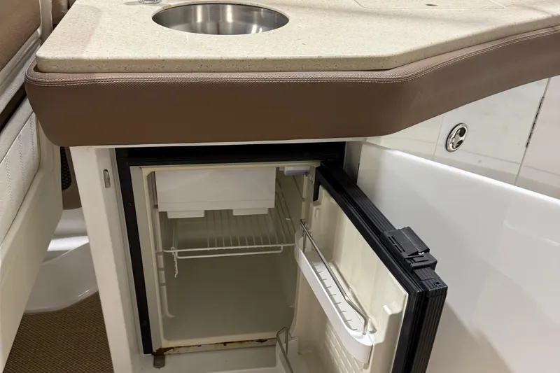 Slide: The Image of Open mini fridge and sink on 2012 Cobalt 262 Bowrider boat. - 6