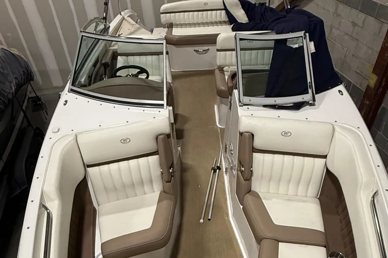 Slide: The Image of 2012 Cobalt 262 Bowrider boat interior with white and brown seating. - 7