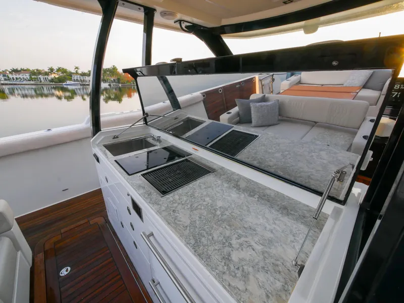 Slide: The Image of 2020 Ocean Alexander 45 Divergence Sport yacht interior with sleek kitchen and seating area. - 10