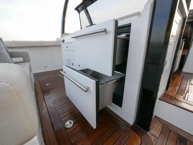 Slide: The Image of 2020 Ocean Alexander 45 Divergence Sport yacht with open storage drawers on teak deck. - 12