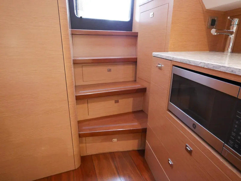 Slide: The Image of Interior of 2020 Ocean Alexander 45 Divergence Sport, featuring wooden stairs and a modern kitchen area. - 33