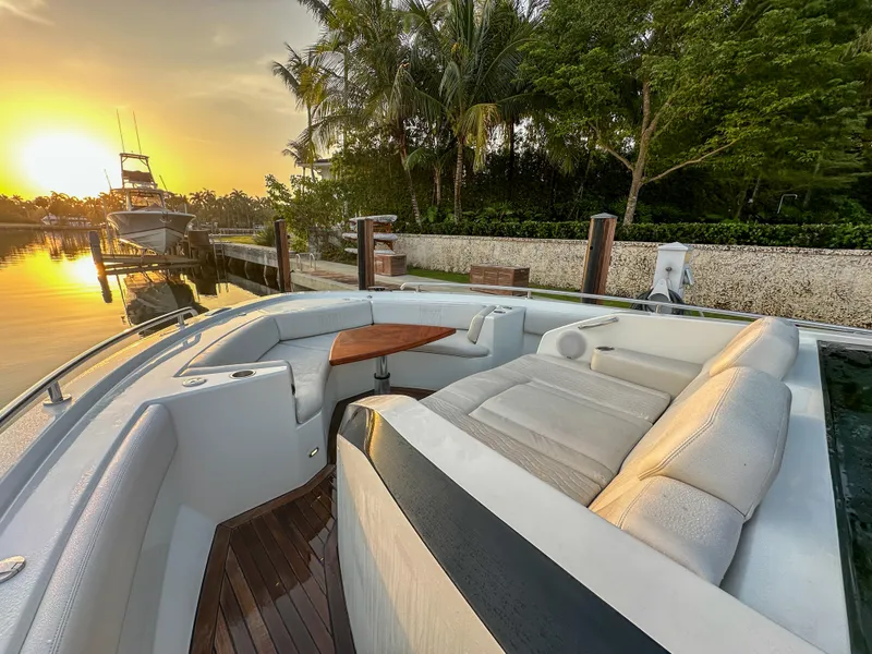 Slide: The Image of 2020 Ocean Alexander 45 Divergence Sport yacht at sunset, featuring luxurious seating and scenic marina view. - 34