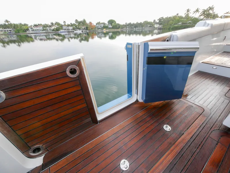 Slide: The Image of 2020 Ocean Alexander 45 Divergence Sport yacht with open side door, wooden deck, and serene water view. - 5