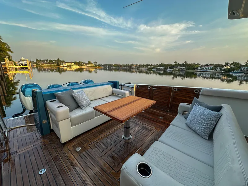 Slide: The Image of Luxury seating area on 2020 Ocean Alexander 45 Divergence Sport yacht, overlooking serene waters. - 7