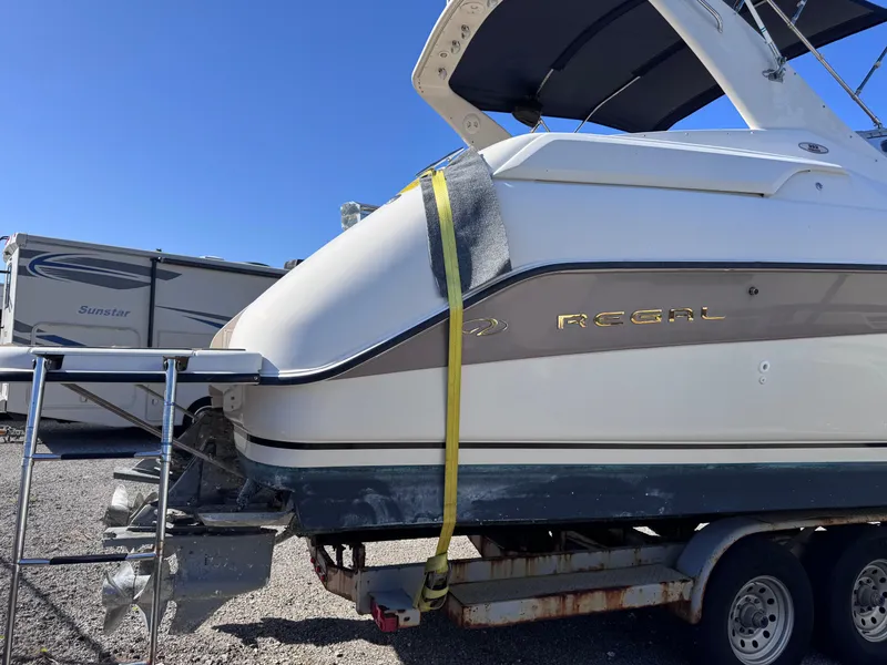 Slide: The Image of 1999 Regal 322 Commodore boat on trailer, side view, sunny day. - 11