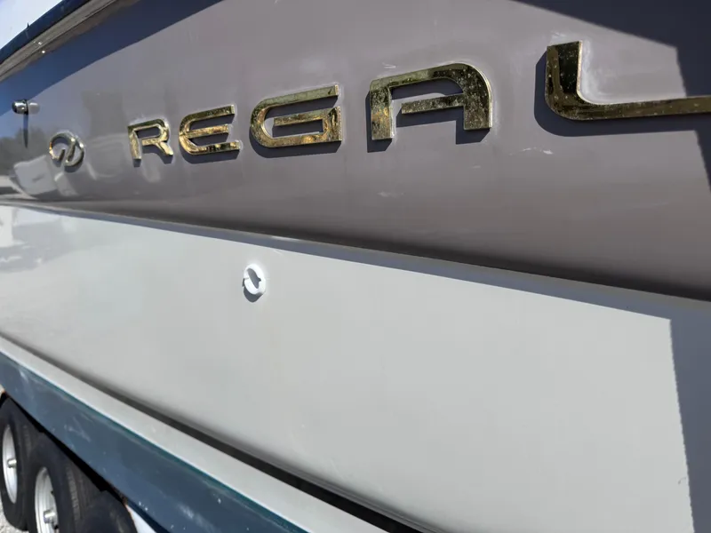 Slide: The Image of 1999 Regal 322 Commodore boat side view with logo in focus. - 15