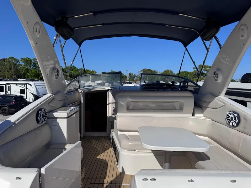 Slide: The Image of 1999 Regal 322 Commodore boat interior with seating and table under canopy. - 17