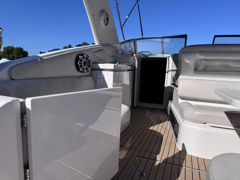 Slide: The Image of 1999 Regal 322 Commodore boat interior with seating and open cabin door. - 20