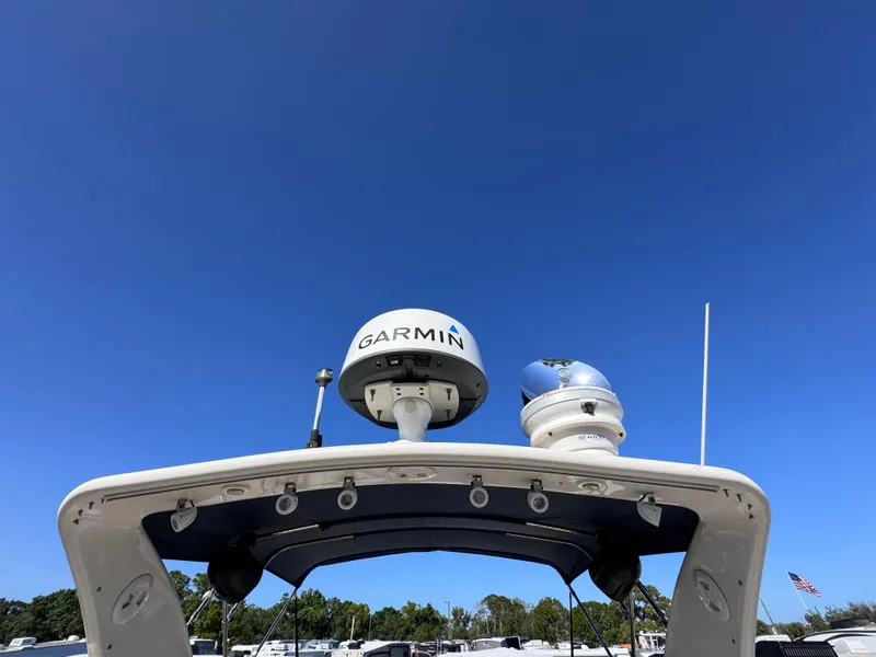 Slide: The Image of 1999 Regal 322 Commodore boat with Garmin radar under clear blue sky. - 21