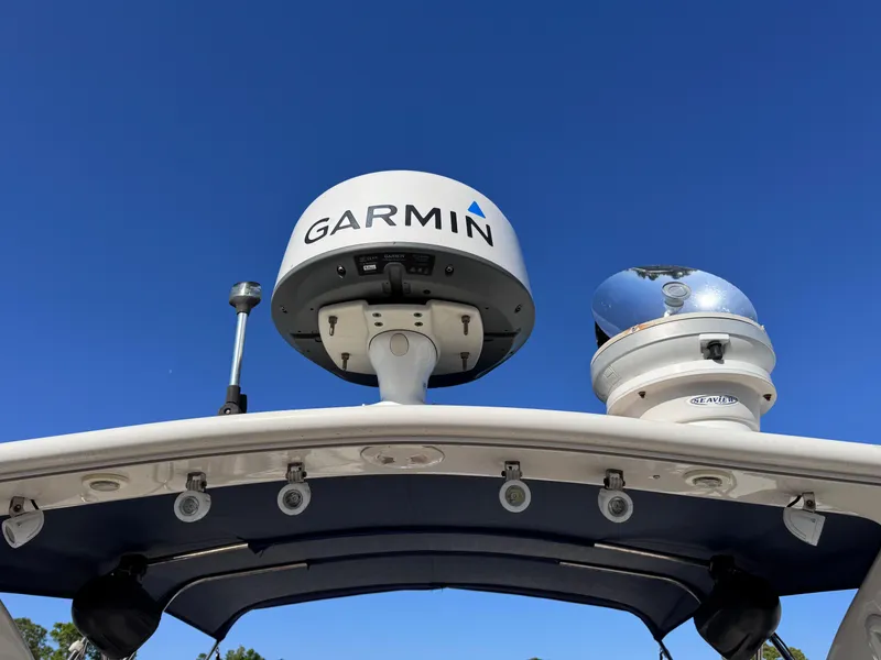 Slide: The Image of Radar equipment on a 1999 Regal 322 Commodore boat under clear blue sky. - 22