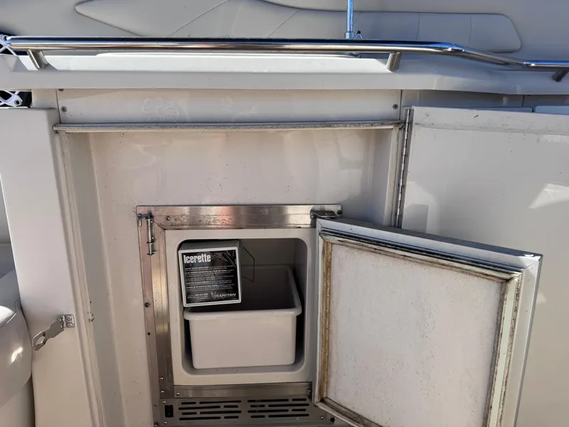 Slide: The Image of 1999 Regal 322 Commodore boat interior with open mini fridge. - 29