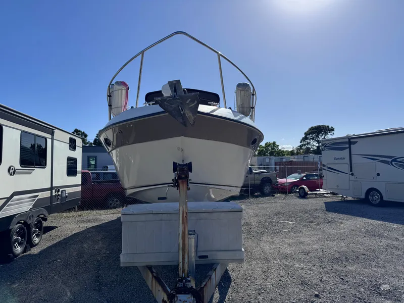 Slide: The Image of 1999 Regal 322 Commodore boat on trailer in outdoor storage lot. - 3