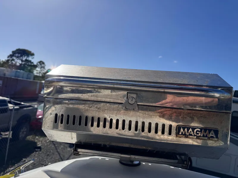 Slide: The Image of Stainless steel Magma grill on 1999 Regal 322 Commodore boat, sunny day background. - 35