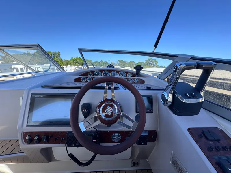 Slide: The Image of 1999 Regal 322 Commodore boat helm with steering wheel and control panel. - 37