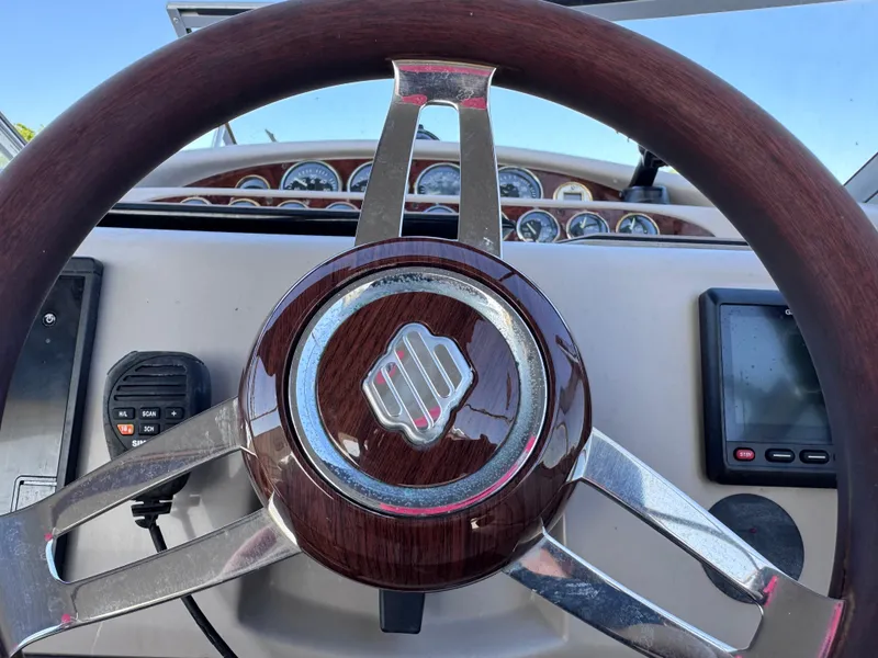 Slide: The Image of Steering wheel of a 1999 Regal 322 Commodore boat with dashboard instruments. - 39