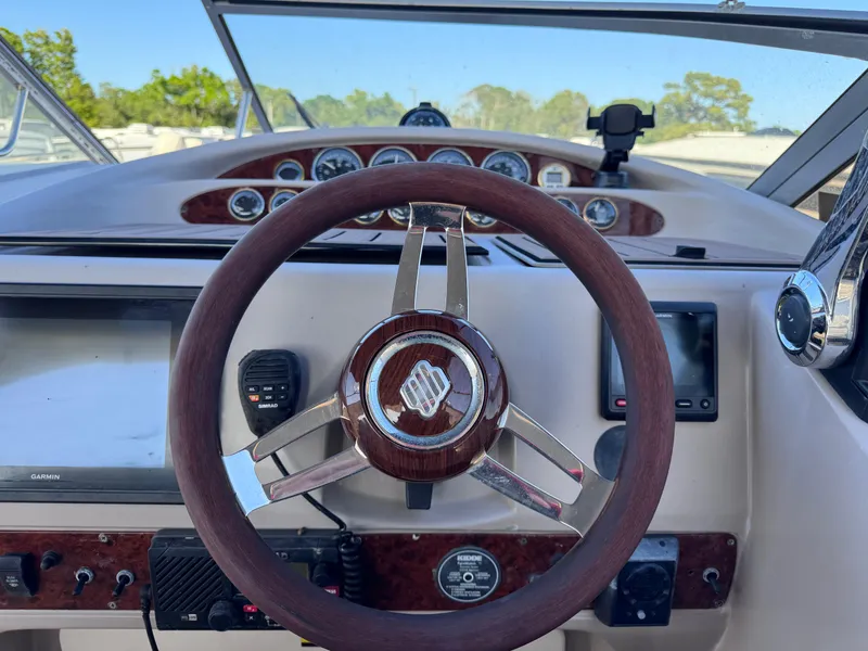 Slide: The Image of 1999 Regal 322 Commodore boat dashboard with steering wheel and navigation instruments. - 40