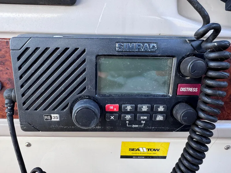Slide: The Image of Simrad RS35 marine radio on 1999 Regal 322 Commodore boat dashboard. - 43