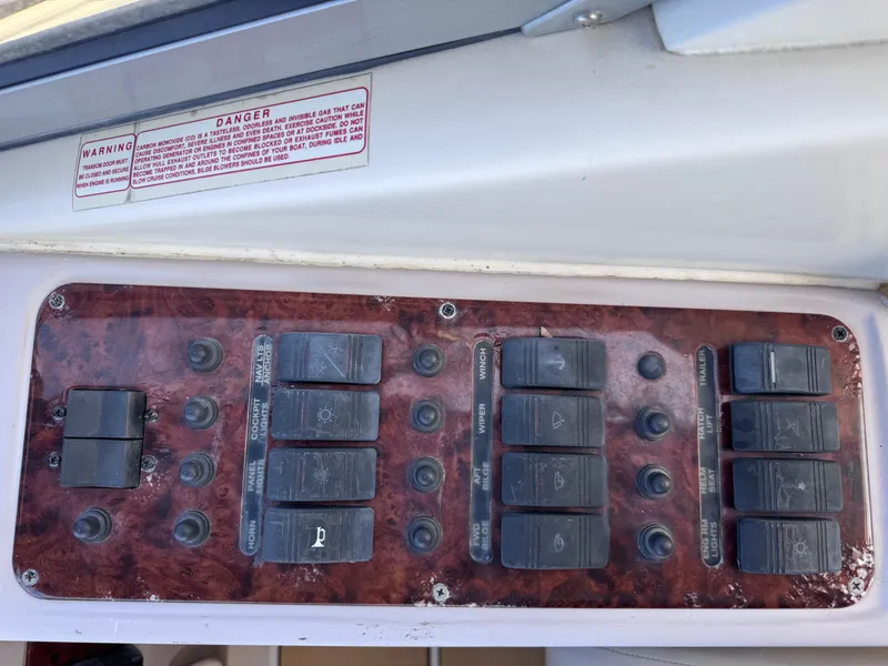 Slide: The Image of Control panel of a 1999 Regal 322 Commodore boat with various switches. - 45