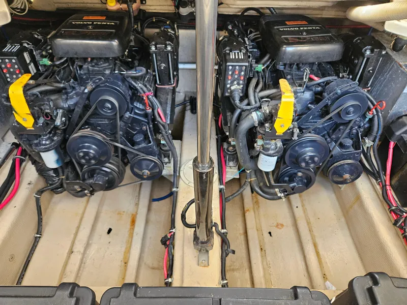 Slide: The Image of Twin engines in a 1999 Regal 322 Commodore boat, showcasing detailed mechanical components. - 96