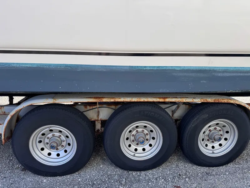 Slide: The Image of 1999 Regal 322 Commodore boat on a triple-axle trailer. - 97