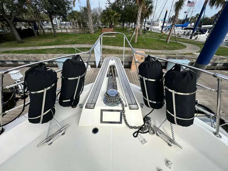 Slide: The Image of 1978 Hatteras 53 Motor Yacht bow with fenders and anchor chain, docked at marina. - 16