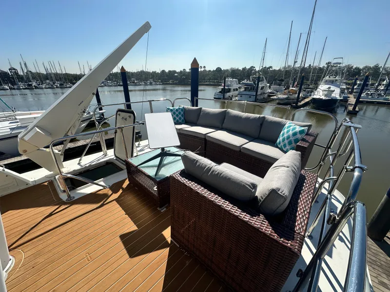 Slide: The Image of 1978 Hatteras 53 Motor Yacht deck with outdoor seating and marina view. - 22
