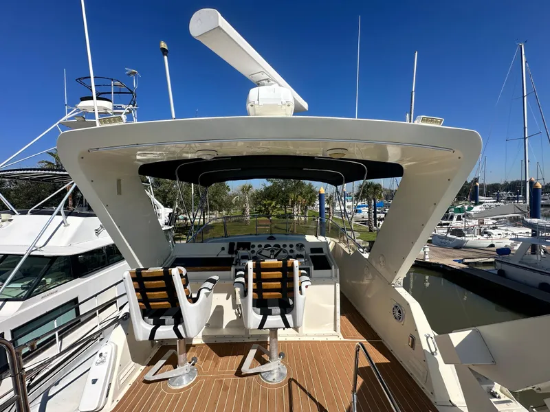 Slide: The Image of 1978 Hatteras 53 Motor Yacht helm with dual captain chairs and navigation equipment. - 23