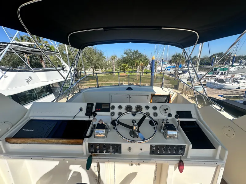 Slide: The Image of Cockpit view of 1978 Hatteras 53 Motor Yacht with steering wheel and controls. - 24
