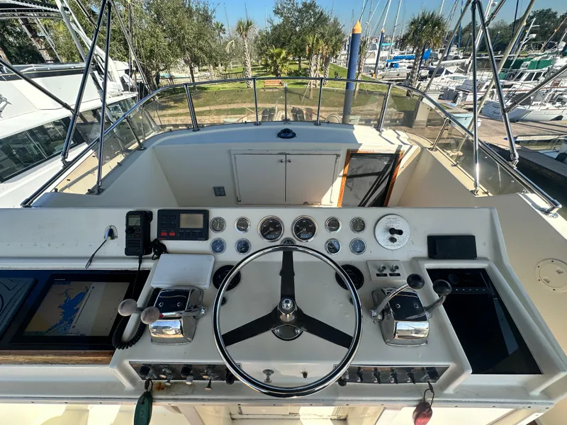 Slide: The Image of 1978 Hatteras 53 Motor Yacht helm with steering wheel and navigation instruments. - 25