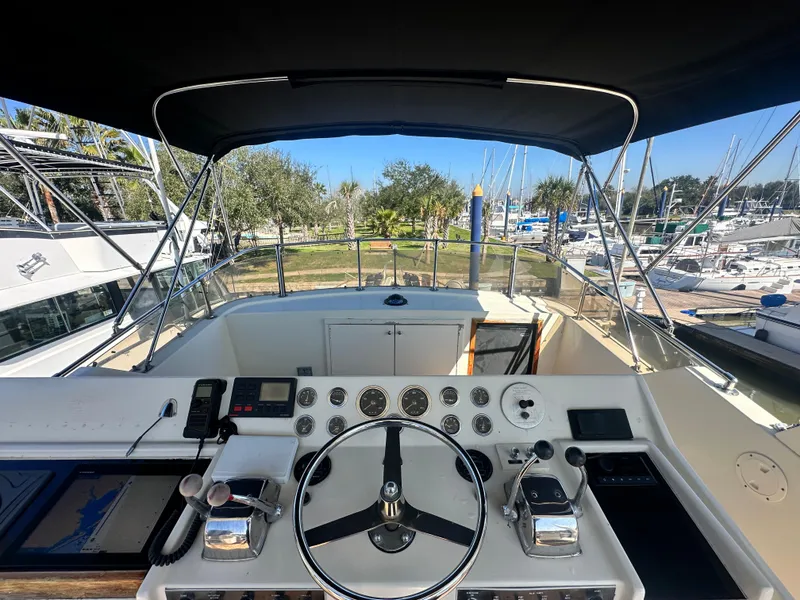 Slide: The Image of Cockpit view of a 1978 Hatteras 53 Motor Yacht, showcasing steering and controls. - 26