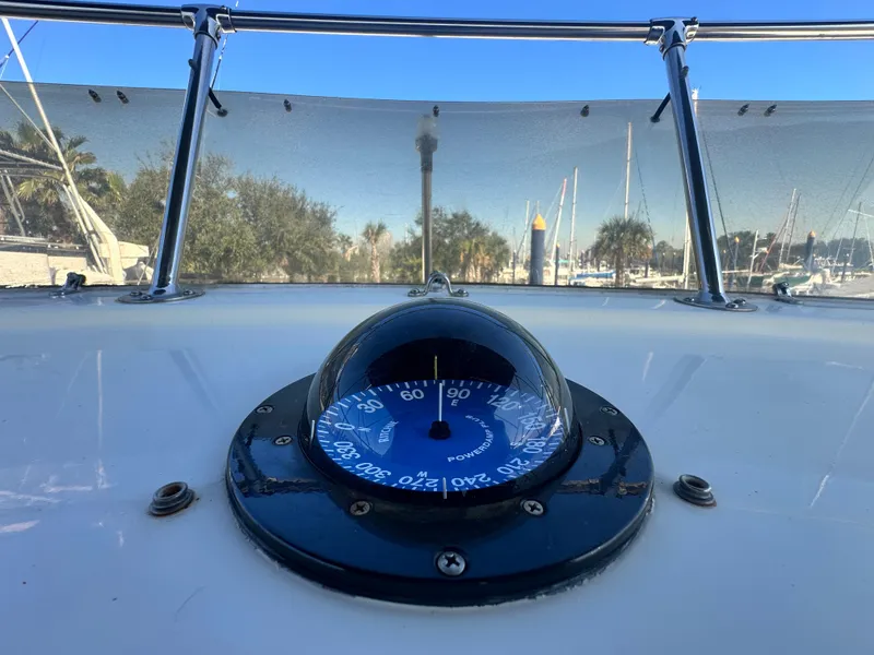 Slide: The Image of Compass on 1978 Hatteras 53 Motor Yacht, with marina view in background. - 33