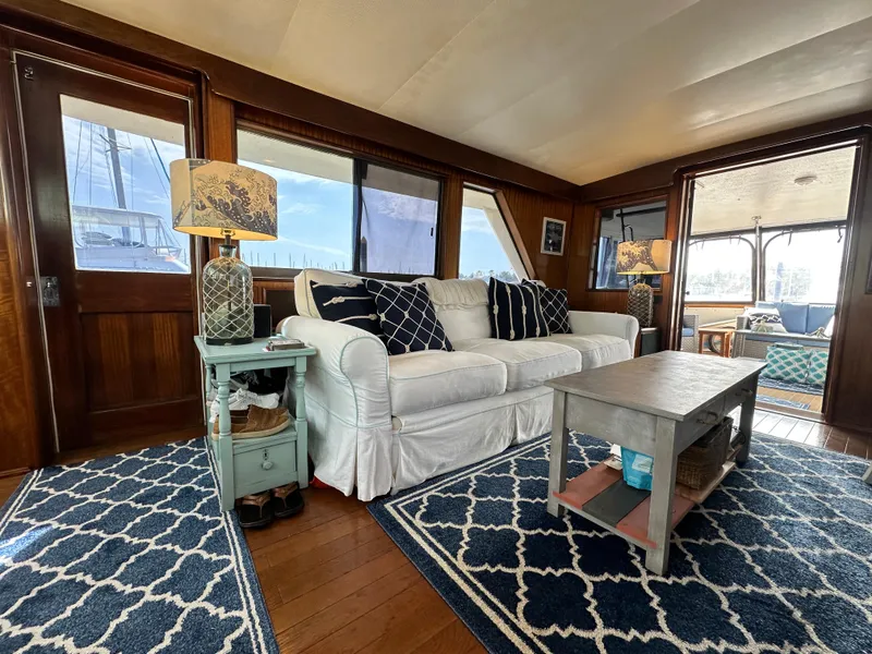 Slide: The Image of Interior of 1978 Hatteras 53 Motor Yacht with cozy seating and nautical decor. - 36